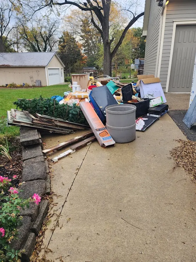 Dumpster being loaded with debris for Residential Dumpster Rental in Prairie Grove